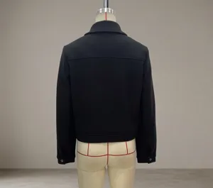 Rear view of black cropped tweed jacket with drop shoulders and elasticated hemline detail