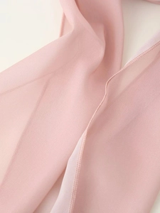 Détail du tissu en mousseline rose translucide avec couture fine d'ourlet roulé