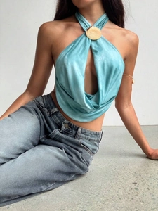 Detail of light blue satin halter top with deep V-cut and gold shell metal hardware