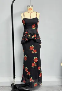 Detailed view of black floral maxi dress with layered ruffles and vibrant red flower print