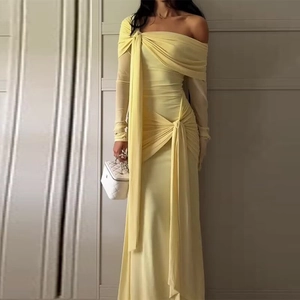 Elegant slim-fit light yellow off-shoulder long dress with draped sash detail and pleats