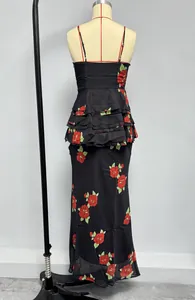Detail of floral print maxi dress featuring red roses and tiered peplum waist detail