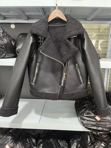 Détail d'une veste aviateur en similicuir noir avec doublure en peau lainée et fermetures