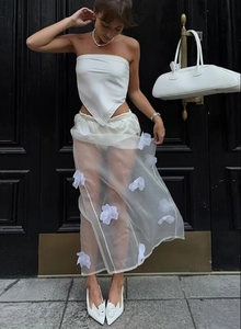 Detail showing 3D floral appliques on semi-transparent white mesh maxi skirt