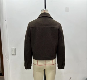 Back view of dark brown cropped tweed jacket with structured yoke and buttoned cuffs