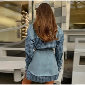 Back view of plaid patchwork denim dress with drawstring waist and raw hem detail