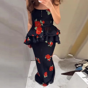 Detailed close-up of a black off-shoulder floral dress with ruffled waist and red patterns