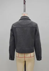 Detail of dark grey short tweed jacket featuring a classic collar and back view texture