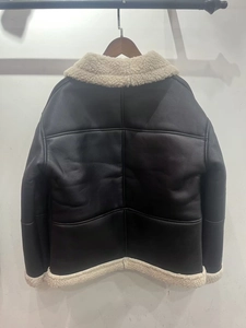 Detail of faux leather aviator jacket with white faux shearling collar and cross stitching
