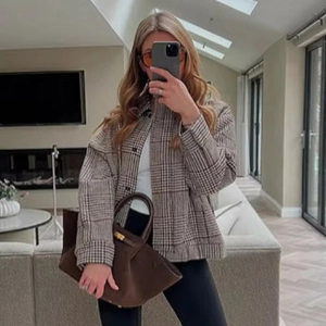 Women's vintage brown plaid bomber jacket with oversized fit and classic button design