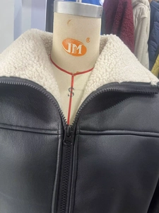 Detail of matte black faux leather jacket with white faux shearling fur collar trim