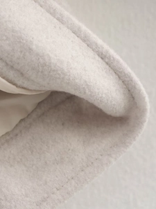 Macro detail of high-quality wool blend fabric texture with smooth satin lining
