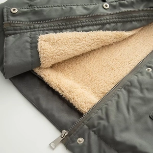 Detailed close-up of thickened fleece lining and dual metal zipper closure on parka jacket