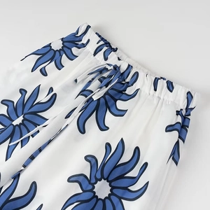 Detail showing elastic waist with drawstring on blue floral print cotton pants