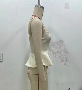 Detail view of white peplum camisole top with ruffled hem on a professional mannequin