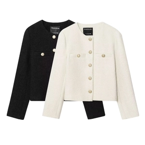 Detail of tweed fabric texture and gold buttons on black and beige cropped jackets
