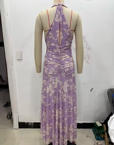 Detail of floral print maxi dress featuring an open back and gathered waist detail