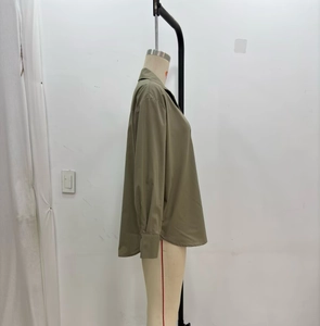 Side view of army green poplin shirt with curved hem and classic pointed collar