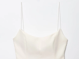 Detail view of cream white camisole top with structured seams and invisible side zipper