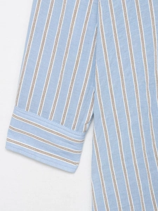 Close-up of vertical striped cotton-linen shirt cuff with precise stitching and fabric texture