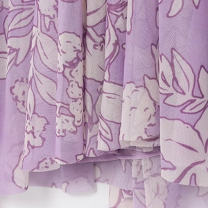 Close-up of lavender floral print mesh fabric with delicate mesh texture and hem details