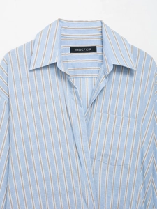 Close-up of the classic collar and chest pocket on blue and white striped shirt