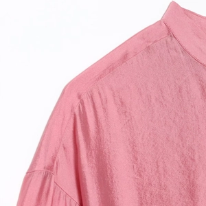 Elegant pink satin blouse for women featuring ruffled collar and delicate silk texture