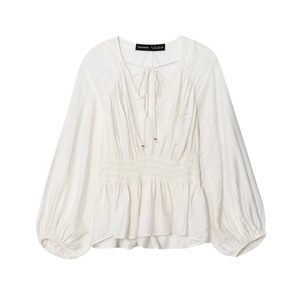 White long sleeve V-neck blouse with shirred waist and textured puff sleeves