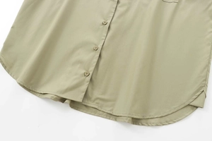 Detail of sage green poplin shirt featuring a curved hem and matching buttons