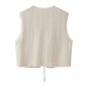 Detail of floral lace trim and drawstring beads on a beige textured cotton vest back