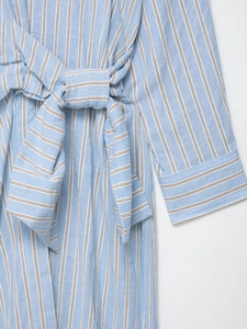 Detail view of the striped cotton fabric texture and waist tie on the casual blue dress
