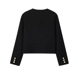 Rear view of black tweed jacket with elegant golden embossed buttons on the sleeves