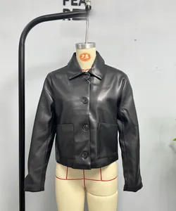 Detail view of black cropped leather jacket featuring lapels and large square pockets
