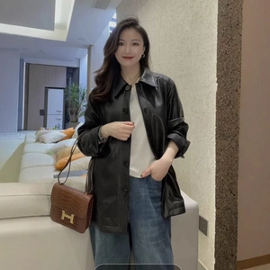 Women's black faux leather mid-length coat with classic lapel and button closure