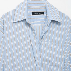Classic light blue striped button-down shirt with a front pocket and standard collar