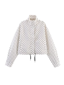 Detailed view of white polka dot jacket featuring a stand collar and adjustable black drawstring