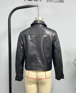 Detail view of the back seams and tailored fit of a black short faux leather jacket