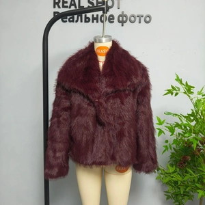 Detailed view of a wine red faux fur coat with a plush lapel and thick texture