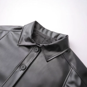 Short black leather jacket with turnover collar and resin buttons for women