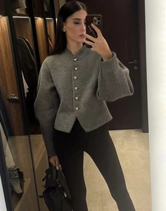 Detailed texture of dark grey wool jacket with elegant silver metal buttons