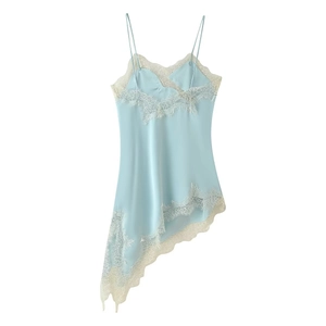 Detail of light blue satin dress featuring white lace trim and asymmetrical hemline