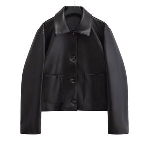 Detail of black faux leather cropped jacket with button-up front and large flap pockets