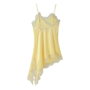 Detail of light yellow satin dress with delicate white lace trim and asymmetrical hemline