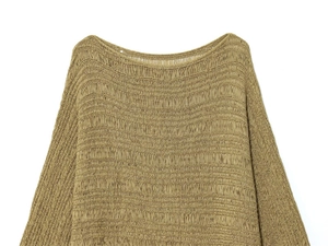 Detail of mustard yellow open knit sweater with textured horizontal patterns and wide neck