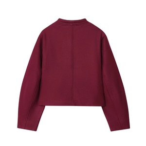Detail view of the back of a minimalist burgundy wool-blend jacket with a central vertical seam