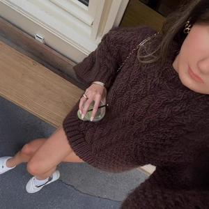 Oversized dark brown cable knit sweater for women with ribbed cuffs and round neck
