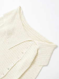 Detail of beige knit cardigan featuring hollow-out texture, wide collar and buttons