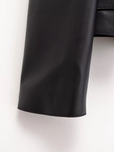 Detail shot of black leather jacket cuff showing premium stitching and grain texture