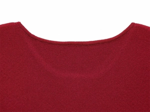 Detailed view of the fine knit texture and round neckline of a red knitted dress