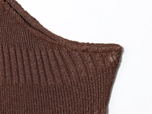 Close-up of brown ribbed knit fabric with metallic glitter and clean edge stitching
